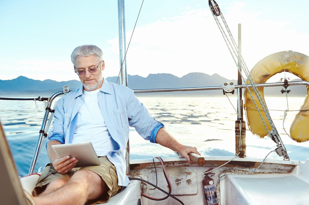 Old man reading on his yacht