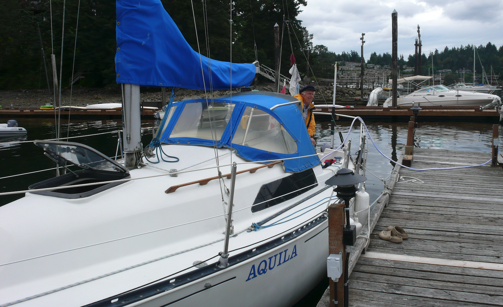 Docked sail boat with man on Deck