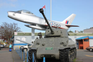 A RCAF fighter jet alongside a classic World War II Sherman Tank