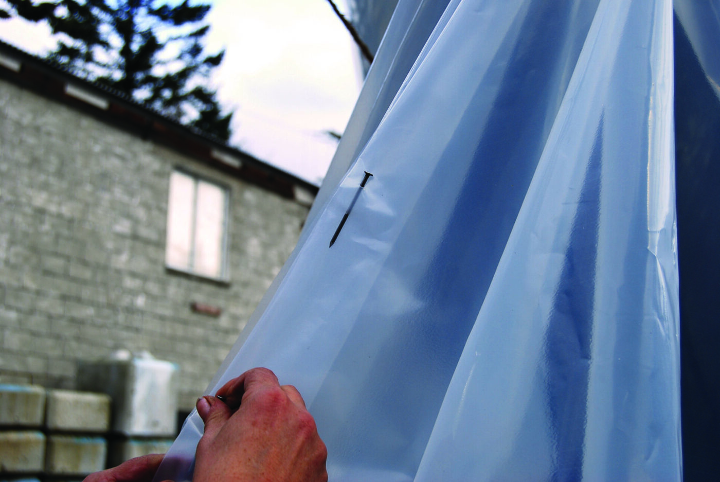 A doorway can be sealed closed by overlap the plastic and use nails to hold it together.