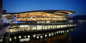 Image of the Vancouver Convention Centre West lit up from the inside at night.